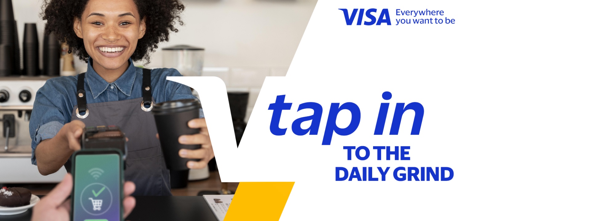 Customer making a contactless Visa payment while buying coffee from a smiling barista