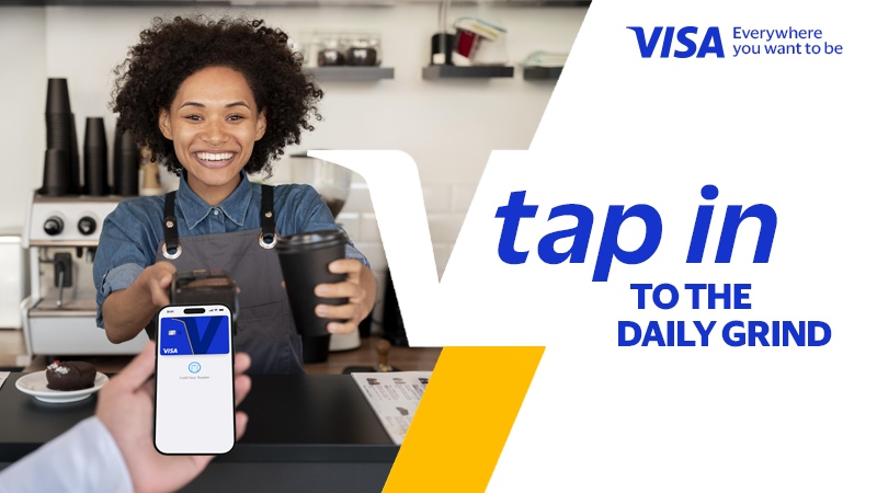 Customer making a contactless Visa payment while buying coffee from a smiling barista
