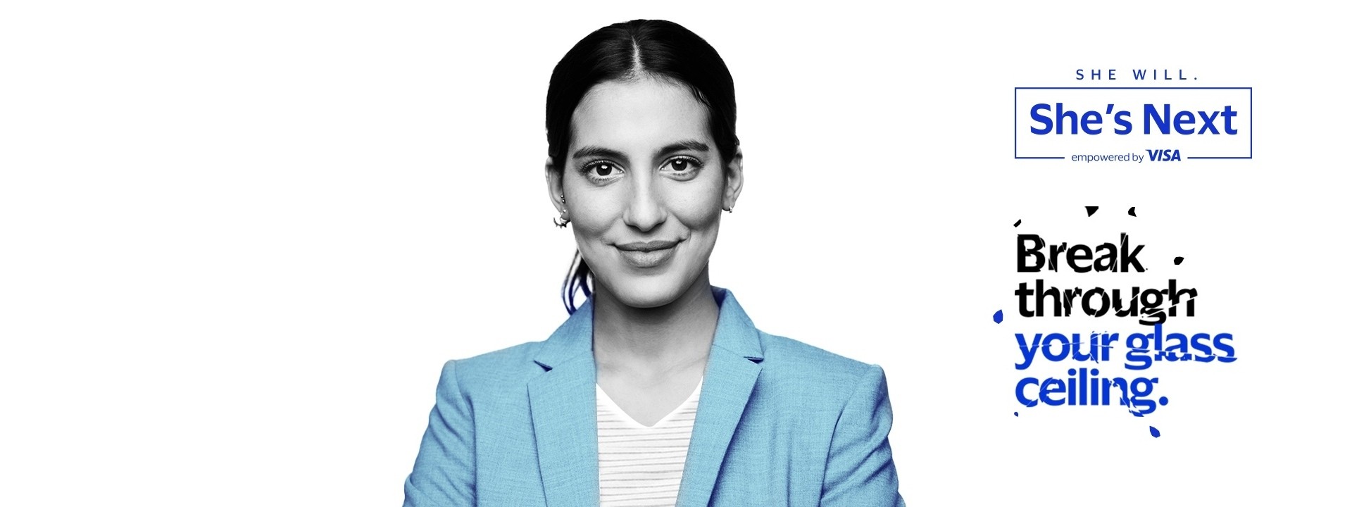 Confident woman in blue blazer with She's Next by Visa campaign slogan