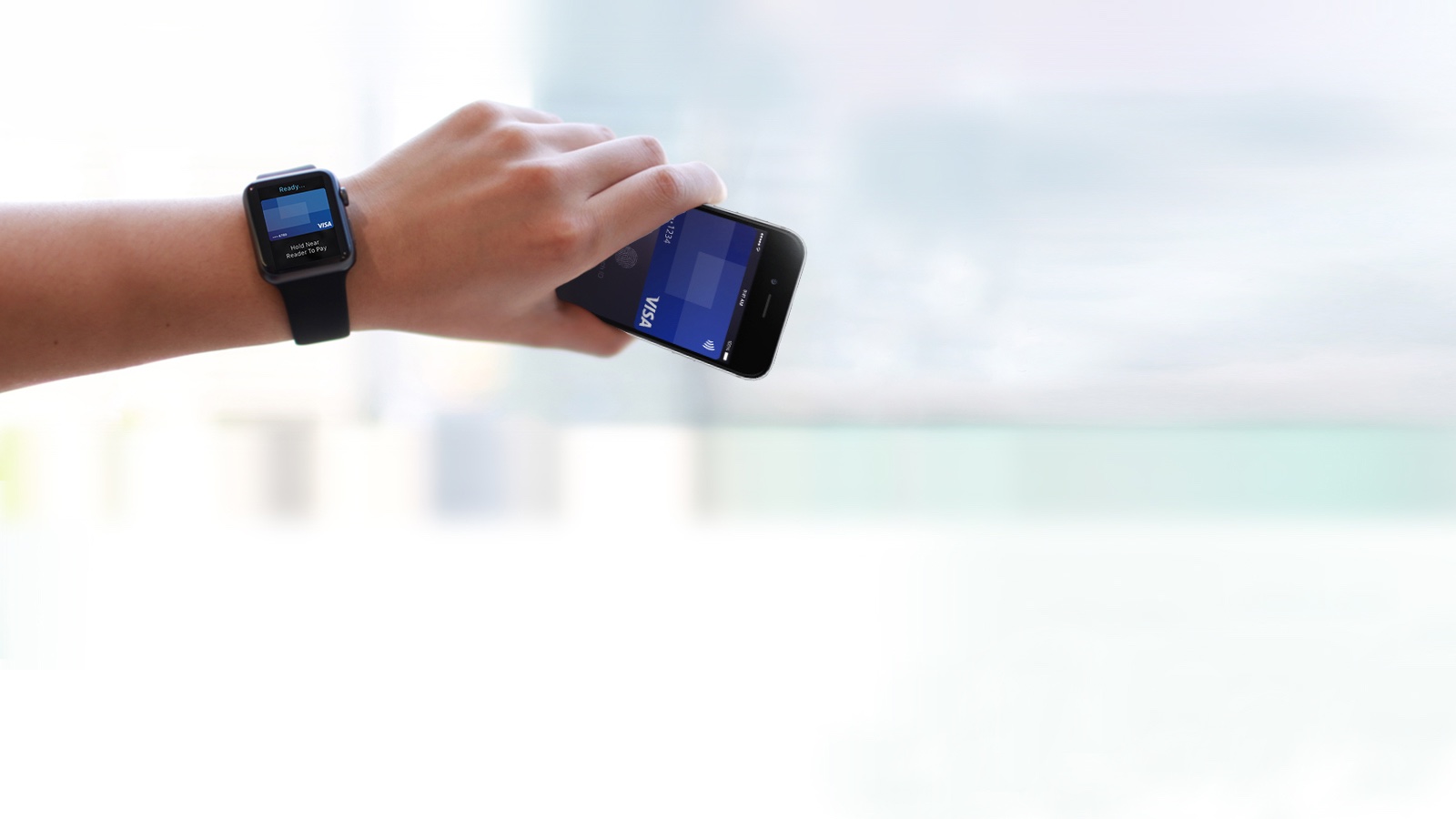 marquee-apple-watch-phone-1600x900 Person wearing Apple watch holding Apple phone.