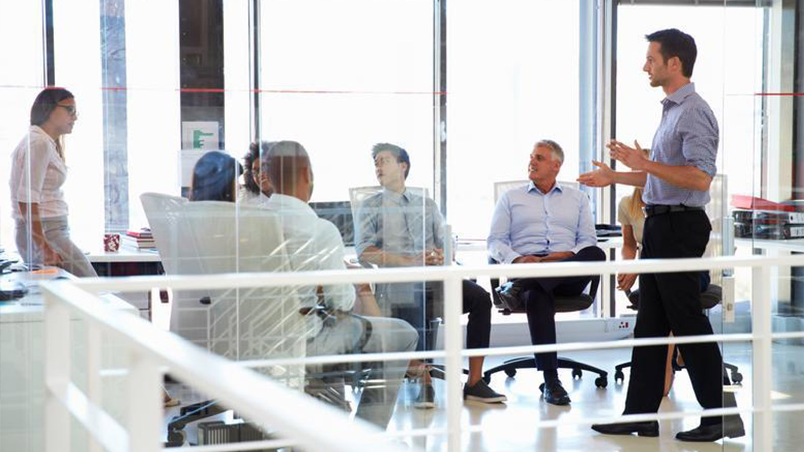 Group of business people in office discussing ideas.