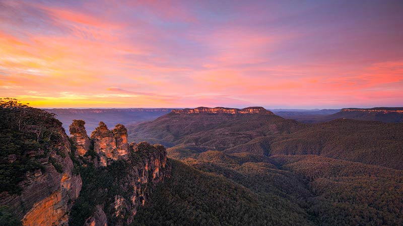 Sunrise over the Jamison Valley and the Three Sisters in the scenic Blue Mountains National Park.